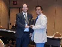Geoffrey Graybeal (Texas Tech University) presents the Second Place Student Paper Award to Dhiman Chattopadhyay (Bowling Green State University), for his paper, "Why do Journalists Resist Change?" #AEJMC16